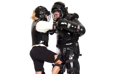 instructor teaching self defense techniques to trainee