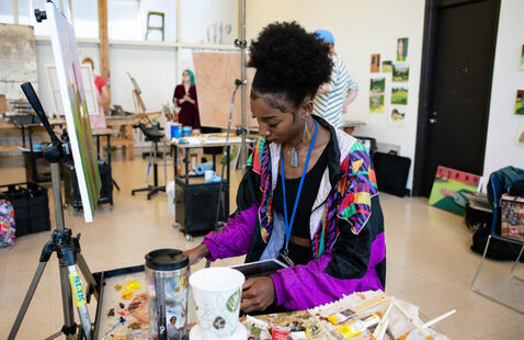 student painting in open studio