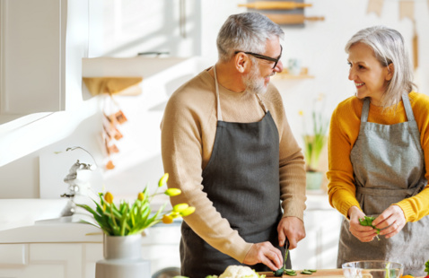 man and woman cooking together
