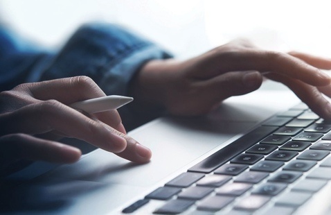 a person typing on a computer
