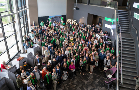 During the aerospace open house families and supporters gather with graduates for a group photo in the Robin Hall atrium.