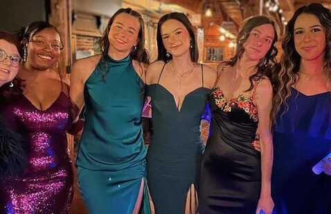 Students pose for a group photo while attending a Greek formal event 