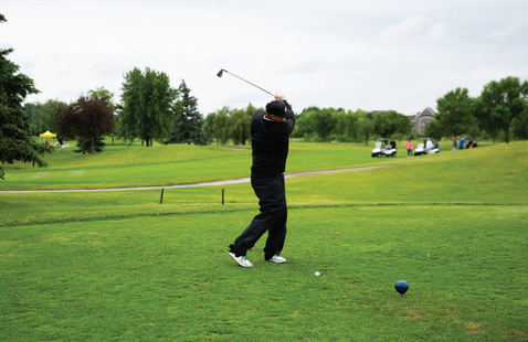 Golfer swinging club