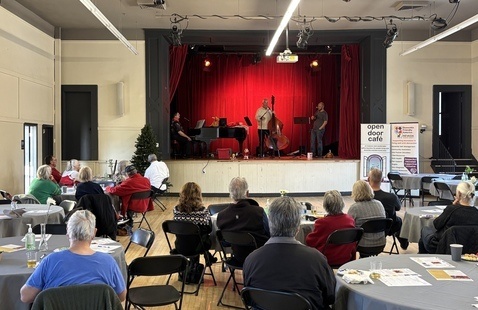 Participants gather and listen to music at the Open Door Café