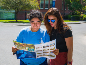 A couple of community members look at a campus map.