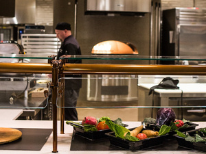 A look into the open kitchen at MHC dining commons, a chef preparing food.