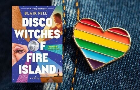 Book cover of Disco Witches of Fire Island next to a rainbow heart shaped pin.