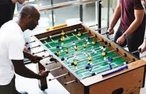 Two people playing foosball. 