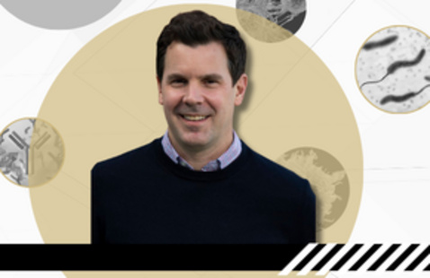 Banner with white background, black and white circular photos of immune and micro organisms, centered in front is a photo of Dr. Tim Hand, wearing a black sweater