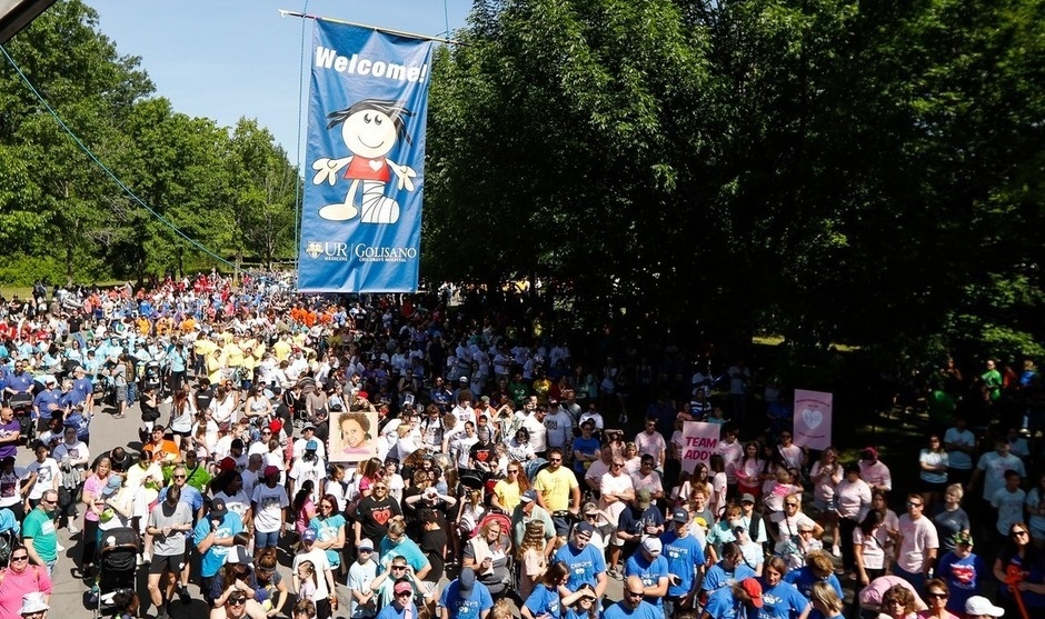 Crowd at the Stroll for Strong kids with a Welcome banner hanging in the air