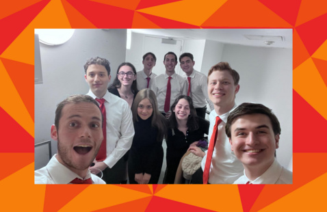 ArtMembers of ApiChorus pose in white button-down shirts and red ties, in a red geometric frame