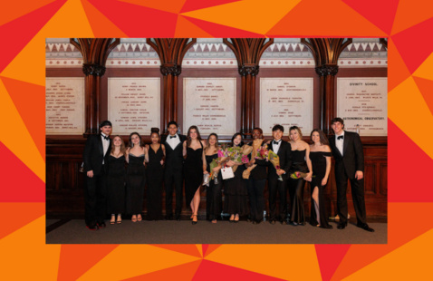 The Harvard-Radcliffe Veritones pose in formal concert attire in Sanders Theater, in a red geometric frame