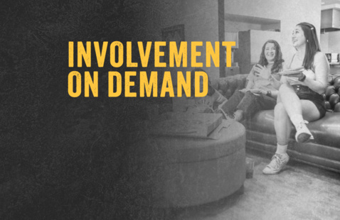 Bolded yellow words that say "Involvement on Demand" on a grey scale background with two college women sitting on a couch.