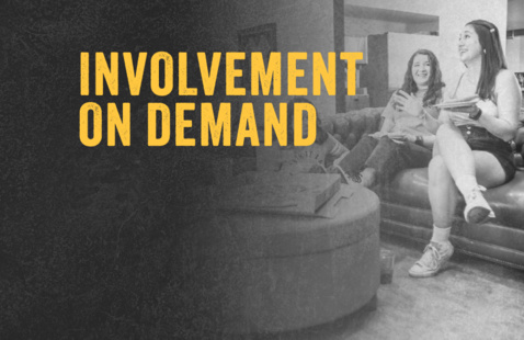 Bolded yellow words that say "Involvement on Demand" on a grey scale background with two college women sitting on a couch. 