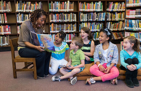 Children sit while listening to a story