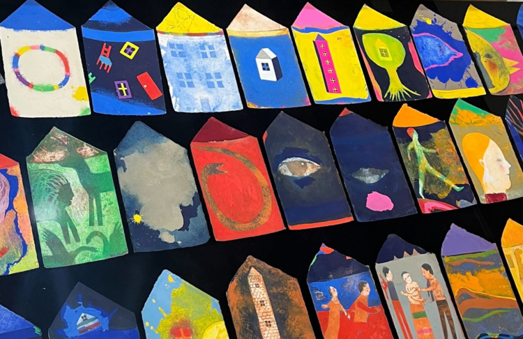 Individual paintings by DeLoss McGraw each in the shape of houses.