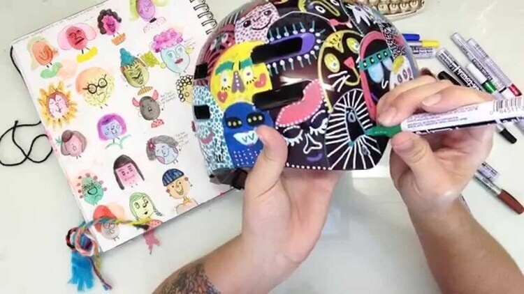 image of someone doodling with a paint pen on a helmet