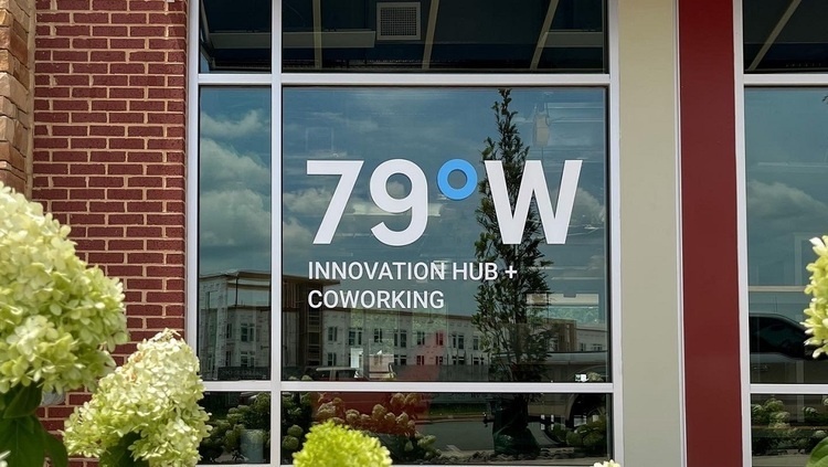 An extertior shot of a window with the logo 79 W Innovation Hub-CoWorking.