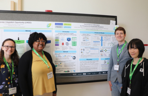 STEPS researchers in front of a research poster.