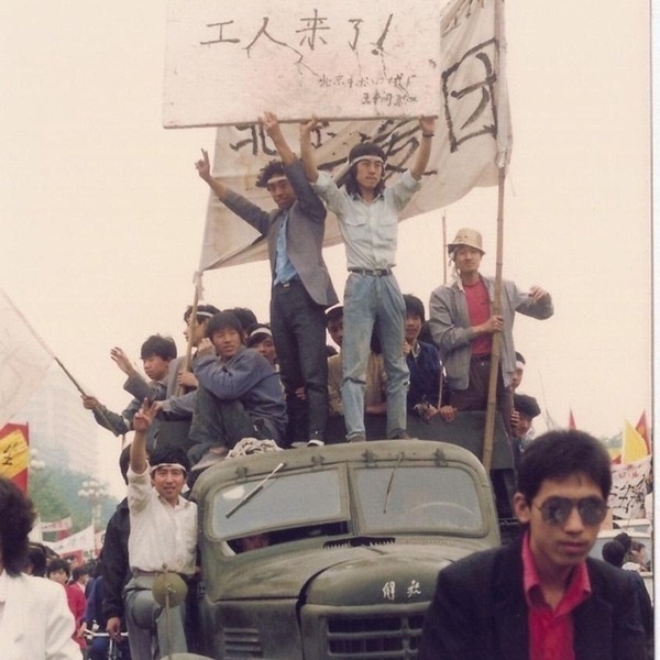 Some Chinese workers atop a truck holding up the sign “The workers are here!” during the 1989 Tiananmen protests.