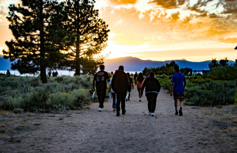 Students walking towards Lake Tahoe at sunset