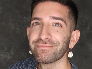 Erik Esqueda faces the camera.