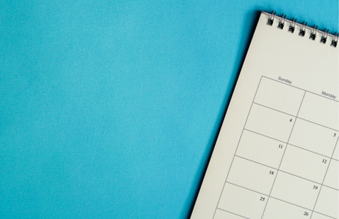 part of white monthly calendar on blue background
