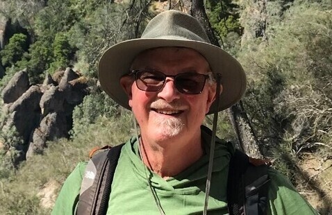 Charles Goodrich smiling outdoors in a hat and sunglasses.