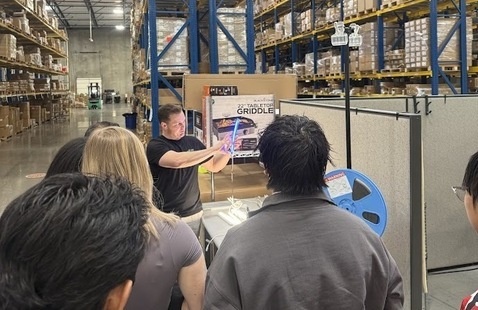 Students in warehouse listening to presenter
