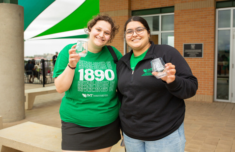 Students at the Farewell Toast in Spring 2024. Each is holding a giveaway glass.