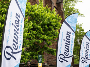 The outside of Mary Woolley Hall with white Reunion banners
