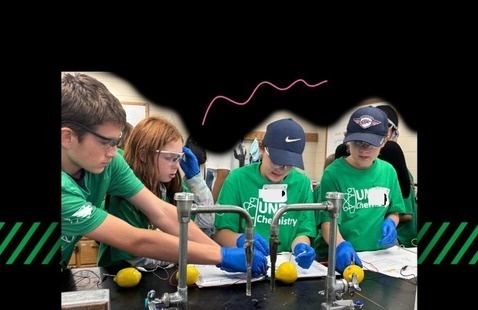 students wearing protective glasses and gloves participating in Chemistry Summer Camp