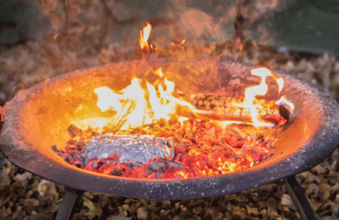 A Ceramic Dutch Oven with a fire inside it.
