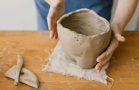 Person holding clay piece