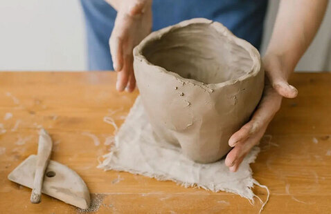 Person holding clay piece