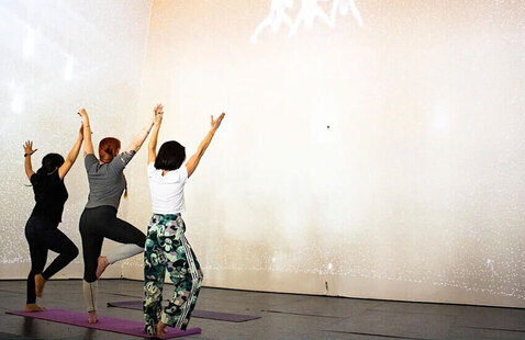 Three women doing yoga poses