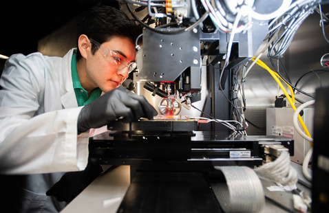 Materials Science & Engineering Graduate Student adjusts an experiment for 2D-3D AM Integration of Electronic Ceramics, Composites, and Metals.