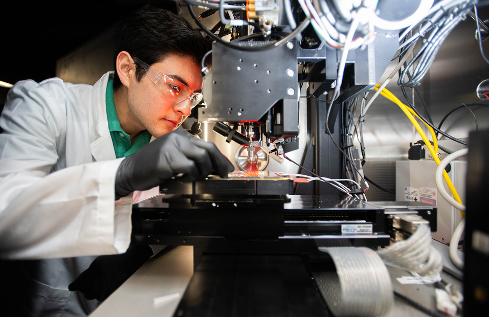 Materials Science & Engineering Graduate Student adjusts an experiment for 2D-3D AM Integration of Electronic Ceramics, Composites, and Metals.