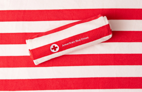red beach towel from red cross