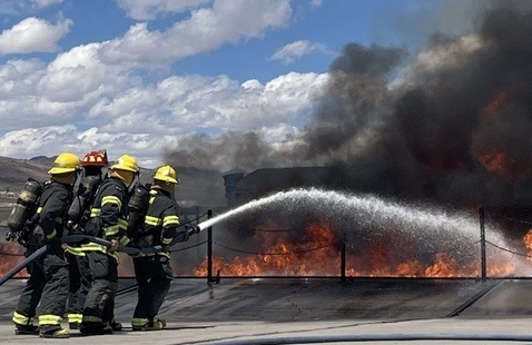 Fast Track Fire Academy cadets practice putting out a fire