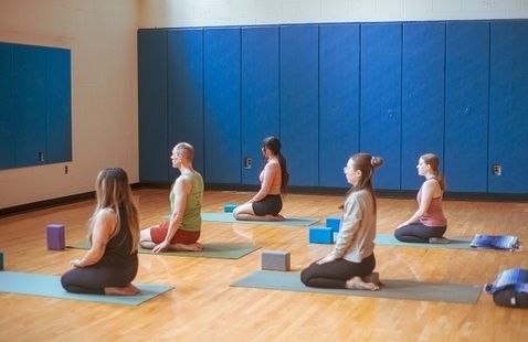 Students practicing yoga in the GAC