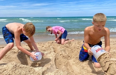 Participants working on sand sculptures at Indiana Dunes State Park