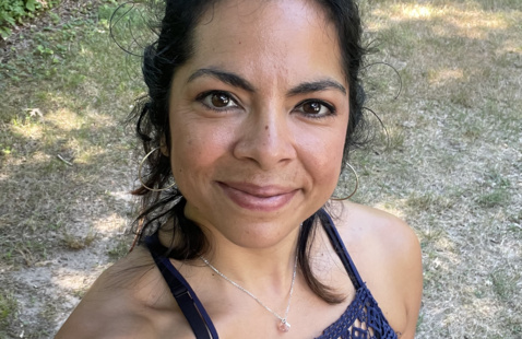 Maritza Alcoreza, yoga teacher, looking into the camera.
