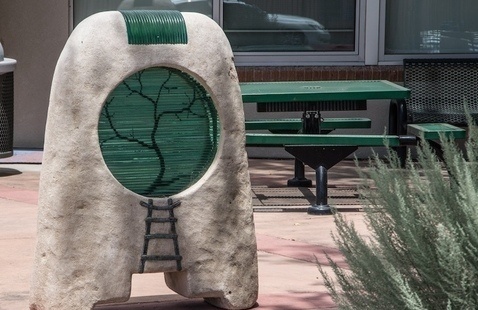 Outdoor sculpture next to Russian Sage in the South Valley courtyard