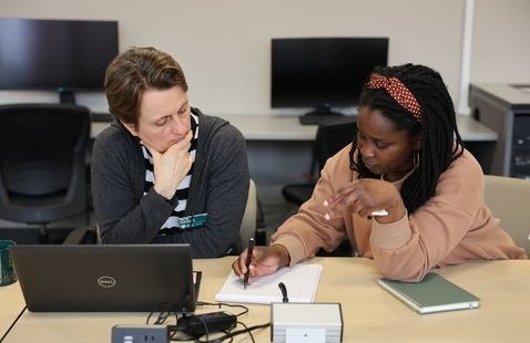 Two people sitting in the CMD lab working together