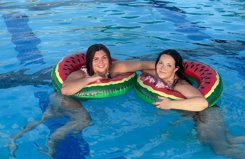 Two female students in a swimming pool