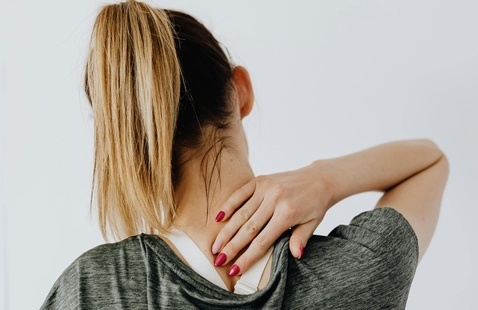 Female experiencing upper back pain
