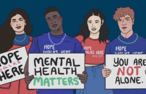 four students holding signs that say: hope walks here, mental health matters, you are not alone