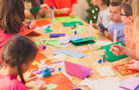 Children doing arts and crafts seated around a table