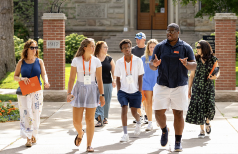 A tour group walks outside around campus.